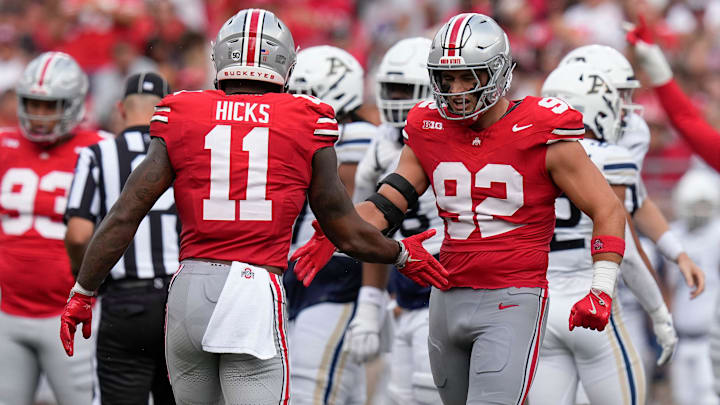 Aug 31, 2024; Columbus, OH, USA; Ohio State Buckeyes defensive end Caden Curry (92) celebrates a sack by linebacker C.J. Hicks (11) during the first half of the NCAA football game against the Akron Zips at Ohio Stadium.
