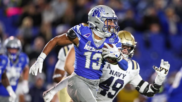 Nov 27, 2025; Memphis, Tennessee, USA; Memphis Tigers running back Greg Desrosiers Jr. (13) runs with the ball against the Navy Midshipmen during the first half at Simmons Bank Liberty Stadium. Mandatory Credit: Wesley Hale-Imagn Images
