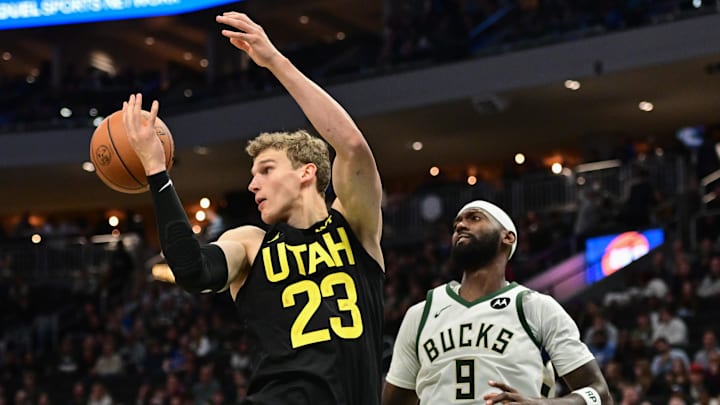 Nov 7, 2024; Milwaukee, Wisconsin, USA;  Utah Jazz forward Lauri Markkanen (23) reaches for a rebound against Milwaukee Bucks forward Bobby Portis (9) in the third quarter at Fiserv Forum. Mandatory Credit: Benny Sieu-Imagn Images