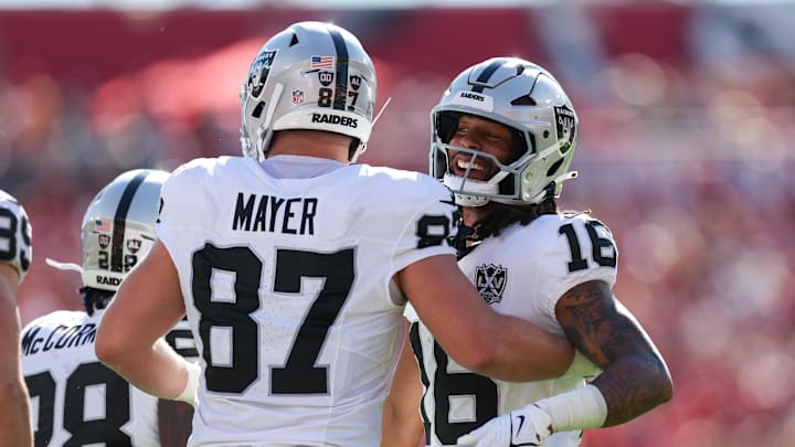 Dec 8, 2024; Tampa, Florida, USA; Las Vegas Raiders wide receiver Jakobi Meyers (16) and tight end Michael Mayer (87) celebrate after a play against the Tampa Bay Buccaneers in the first quarter at Raymond James Stadium. Mandatory Credit: Nathan Ray Seebeck-Imagn Images