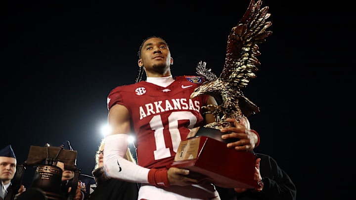 Dec 27, 2024; Memphis, TN, USA; Arkansas Razorbacks quarterback Taylen Green (10) holds the AutoZone Liberty Bowl MVP trophy after defeating against the Texas Tech Red Raiders at Simmons Bank Liberty Stadium. Mandatory Credit: Petre Thomas-Imagn Images