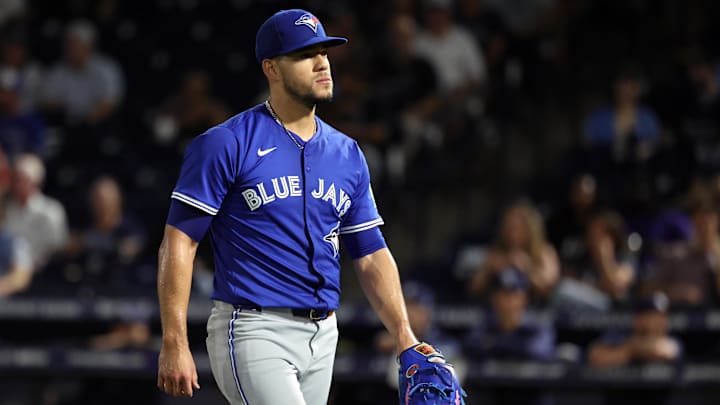 Toronto Blue Jays pitcher Jose Berrios walks to the dugout, wearing a blue jersey and a matching hat. Toronto Blue Jays pitcher Jose Berrios walks to the dugout, wearing a blue jersey and a matching hat.