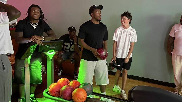 New England Patriots' DeMario Douglas (left), Craig Woodson (seated), and Marcus Jones (ball in hand) taking part in a "Stars & Strikes" bowling tournament in Boston. New England Patriots' DeMario Douglas (left), Craig Woodson (seated), and Marcus Jones (ball in hand) taking part in a "Stars & Strikes" bowling tournament in Boston.