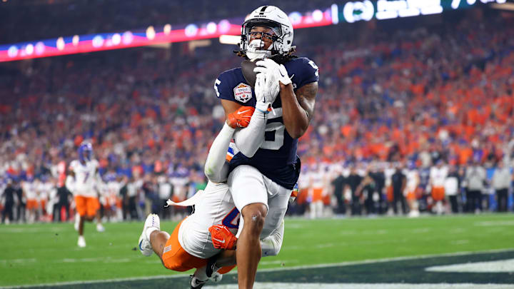 Penn State Nittany Lions wide receiver Omari Evans (5) makes a touchdown catch over Boise State Broncos safety Ty Benefield (0) during the first half in the Fiesta Bowl at State Farm Stadium. 