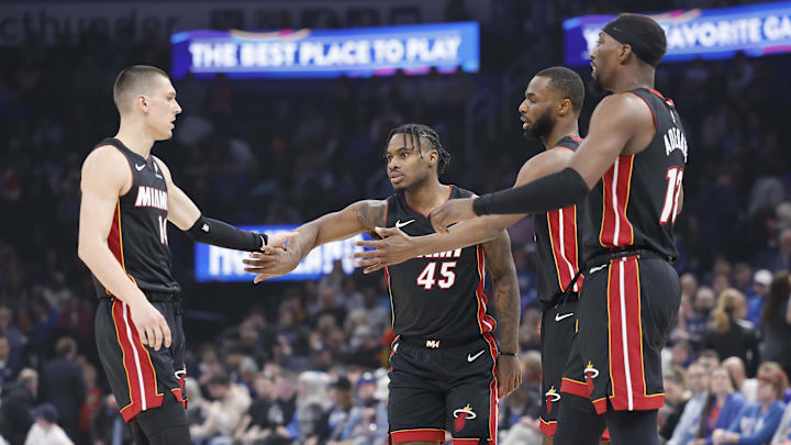 Feb 12, 2025; Oklahoma City, Oklahoma, USA; Miami Heat guard Tyler Herro (14), guard Davion Mitchell (45), forward Andrew Wiggins (22) and center Bam Adebayo (13) high five after a play against the Oklahoma City Thunder during the first quarter at Paycom Center. Mandatory Credit: Alonzo Adams-Imagn Images