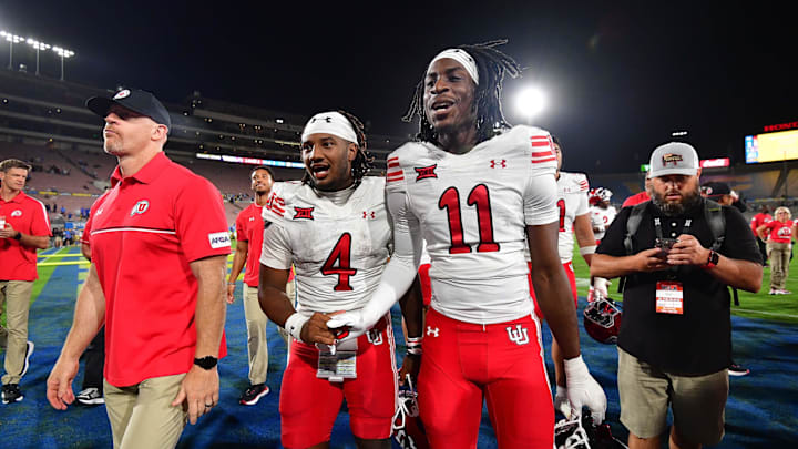 Utah Utes quarterback Devon Dampier (4) and cornerback Rock Caldwell (11) celebrate the victory against the UCLA Bruins  at Rose Bowl.