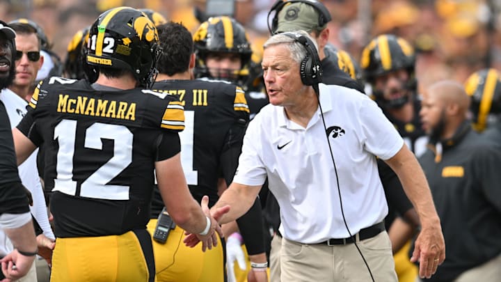 Sep 14, 2024; Iowa City, Iowa, USA; Iowa Hawkeyes head coach Kirk Ferentz reacts with quarterback Cade McNamara (12) after a touchdown against the Troy Trojans during the second quarter at Kinnick Stadium. Mandatory Credit: Jeffrey Becker-Imagn Images