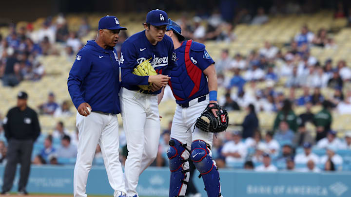 Mar 23, 2026; Los Angeles, California, USA;  Los Angeles Dodgers manager Dave Roberts (left) taking pitcher Roki Sasaki (middle) out from the game during the first inning against the Los Angeles Angels at Dodger Stadium. Mandatory Credit: Kiyoshi Mio-Imagn Images