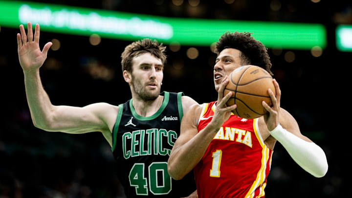 Jalen Johnson #1 of the Atlanta Hawks drives against Luke Kornet #40 of the Boston Celtics.