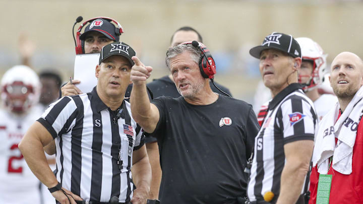 Utah Utes head coach Kyle Whittingham talks to several officials during the third quarter against the West Virginia Mountaineers at Milan Puskar Stadium.