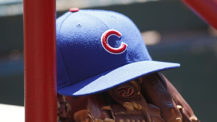 Apr 26, 2015; Cincinnati, OH, USA; A Chicago Cubs hat and glove sits in the dugout during a game with the Cincinnati Reds at Great American Ball Park. Mandatory Credit: David Kohl-Imagn Images