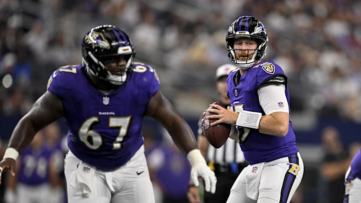 Aug 16, 2025; Arlington, Texas, USA; Baltimore Ravens offensive tackle Corey Bullock (67) drops into protection for quarterback Cooper Rush (15) during the first quarter against the Dallas Cowboys at AT&T Stadium. Mandatory Credit: Jerome Miron-Imagn Images