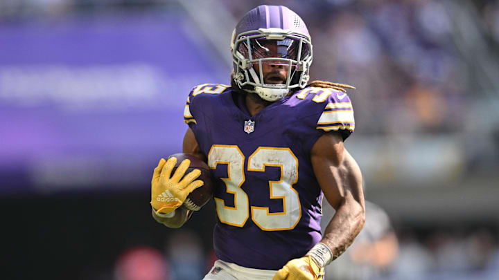 Sep 22, 2024; Minneapolis, Minnesota, USA; Minnesota Vikings running back Aaron Jones (33) runs the ball against the Houston Texans during the fourth quarter at U.S. Bank Stadium.