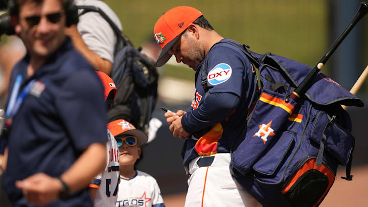 Houston Astros left fielder Jose Altuve signs an autograph. Houston Astros left fielder Jose Altuve signs an autograph.
