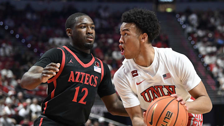 sMar 5, 2024; Las Vegas, Nevada, USA; San Diego State Aztecs guard Darrion Trammell (12) defends against UNLV Rebels guard Dedan Thomas Jr. (11) in the first half at Thomas & Mack Center. Mandatory Credit: Candice Ward-Imagn Images