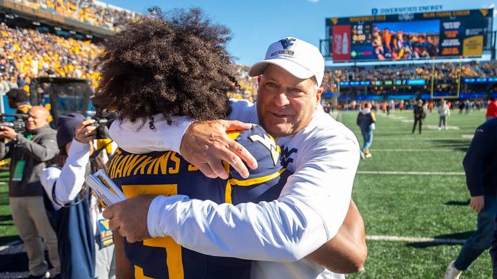 Oct 17, 2026; Morgantown, West Virginia, USA; West Virginia Mountaineers head coach Rich Rodriguez celebrates with quarterback Michael Hawkins Jr. (3) after defeating the Cincinnati Bearcats at Milan Puskar Stadium. Mandatory Credit: Ben Queen-Imagn Images Oct 17, 2026; Morgantown, West Virginia, USA; West Virginia Mountaineers head coach Rich Rodriguez celebrates with quarterback Michael Hawkins Jr. (3) after defeating the Cincinnati Bearcats at Milan Puskar Stadium. Mandatory Credit: Ben Queen-Imagn Images