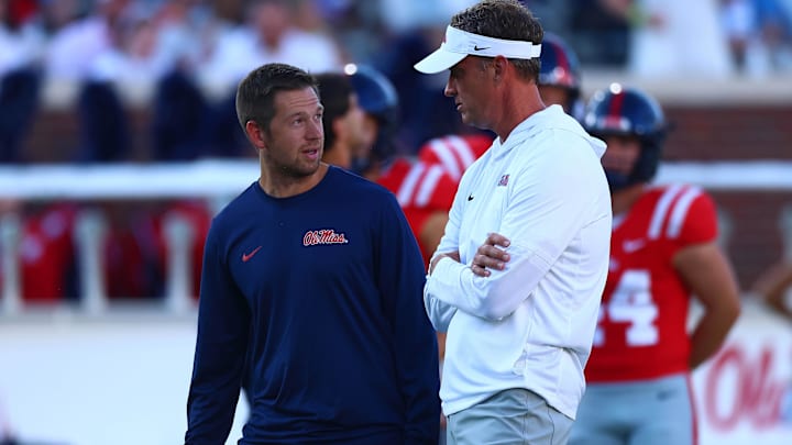 Aug 30, 2025; Oxford, Mississippi, USA; Mississippi Rebels head coach Lane Kiffin (right) talks with offensive coordinator Charlie Weis Jr. during warm ups prior to the game against the Georgia State Panthers at Vaught-Hemingway Stadium. Mandatory Credit: Petre Thomas-Imagn Images Aug 30, 2025; Oxford, Mississippi, USA; Mississippi Rebels head coach Lane Kiffin (right) talks with offensive coordinator Charlie Weis Jr. during warm ups prior to the game against the Georgia State Panthers at Vaught-Hemingway Stadium. Mandatory Credit: Petre Thomas-Imagn Images