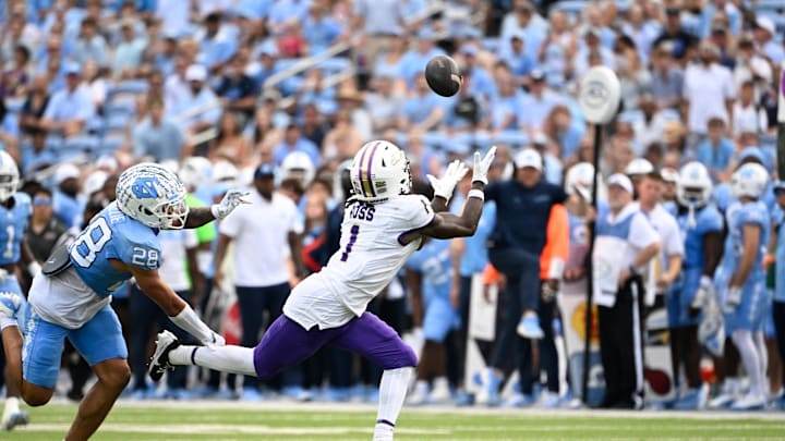 Sep 21, 2024; Chapel Hill, North Carolina, USA; James Madison Dukes wide receiver Cam Ross (1) catches a long pass as North Carolina Tar Heels defensive back Alijah Huzzie (28) defends in the second quarter at Kenan Memorial Stadium. Mandatory Credit: Bob Donnan-Imagn Images