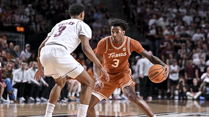 Texas Longhorns guard Dailyn Swain dribbles the ball during the first half as Texas A&M Aggies guard Rylan Griffen defends at Reed Arena. 