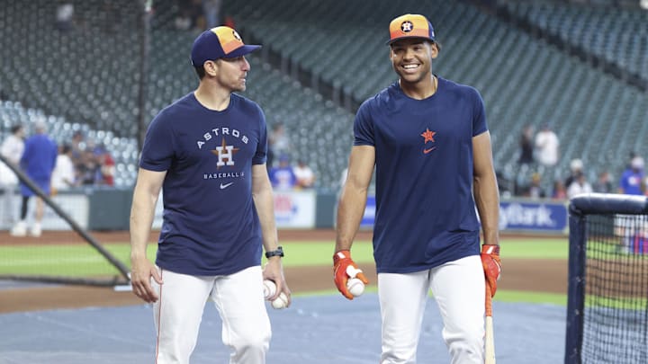 Mar 29, 2025; Houston, Texas, USA; Houston Astros left fielder Cam Smith (right) smiles while talking with hitting coach Troy Snitker before the game against the New York Mets at Daikin Park.