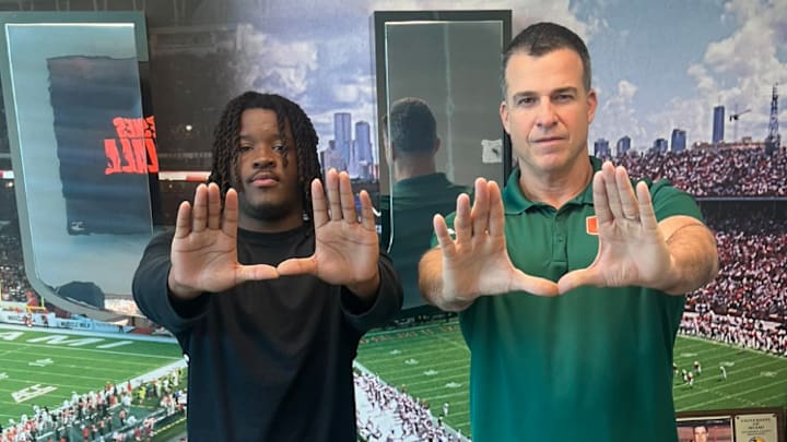 Four-star running back Javian Mallory poses with Miami coach Mario Cristobal