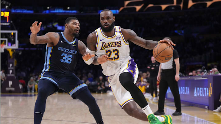 Dec 15, 2024; Los Angeles, California, USA; Los Angeles Lakers forward LeBron James (23) dribbles the ball against Memphis Grizzlies guard Marcus Smart (36) at Crypto.com Arena. Mandatory Credit: Kirby Lee-Imagn Images