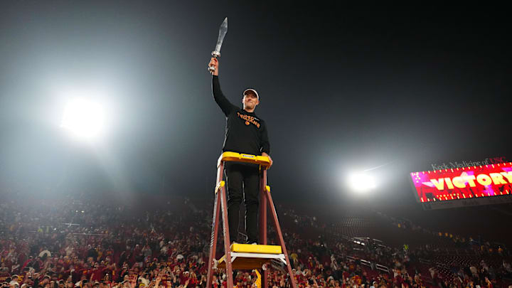 Nov 29, 2025; Los Angeles, California, USA; Southern California Trojans head coach Lincoln Riley leads the Spirit of Troy marching band in a rendition of Tribute to Troy after teh game against the UCLA Bruins at United Airlines Field at Los Angeles Memorial Coliseum. Mandatory Credit: Kirby Lee-Imagn Images
