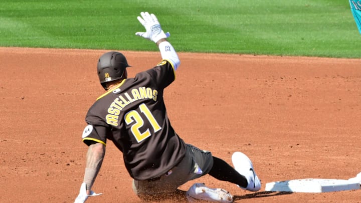 Feb 20, 2026; Peoria, Arizona, USA; San Diego Padres right fielder Nick Castellanos (21) steals a base on Seattle Mariners shortstop Michael Arroyo (96) in the second inning during a Spring Training game at Peoria Sports Complex. Mandatory Credit: Matt Kartozian-Imagn Images