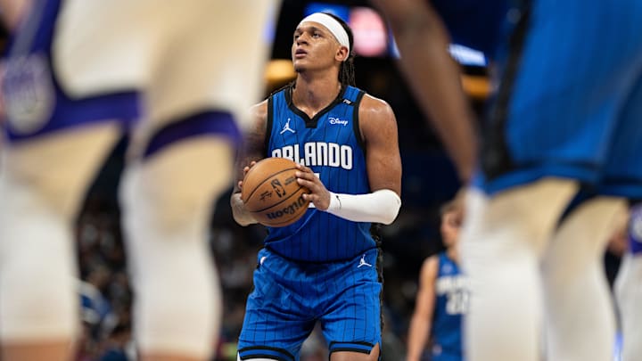 Mar 29, 2025; Orlando, Florida, USA; Orlando Magic forward Paolo Banchero (5) shoots his free throw against the Sacramento Kings in the third quarter at Kia Center. Mandatory Credit: Jeremy Reper-Imagn Images