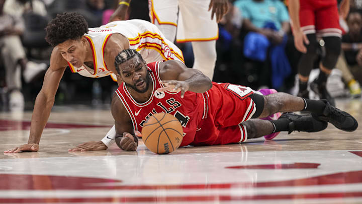 Nov 9, 2024; Atlanta, Georgia, USA; Chicago Bulls forward forward Patrick Williams (44) and Atlanta Hawks forward Jalen Johnson (1) dive for a loose ball on the court during the second  half at State Farm Arena. Mandatory Credit: Dale Zanine-Imagn Images