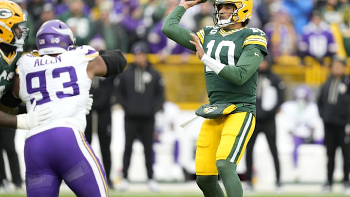 Nov 23, 2025; Green Bay, Wisconsin, USA; Green Bay Packers quarterback Jordan Love (10) looks to throw downfield as Minnesota Vikings defensive tackle Jonathan Allen (93) applies pressure during the first half at Lambeau Field. Mandatory Credit: Kayla Wolf-Imagn Images