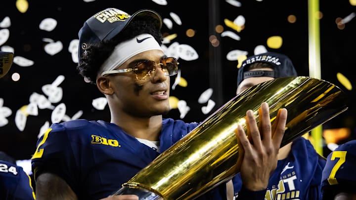Jan 8, 2024; Houston, TX, USA; Michigan Wolverines defensive back Will Johnson (2) celebrates with the championship trophy after defeating the Washington Huskies during the 2024 College Football Playoff national championship game at NRG Stadium. Mandatory Credit: Mark J. Rebilas-Imagn Images