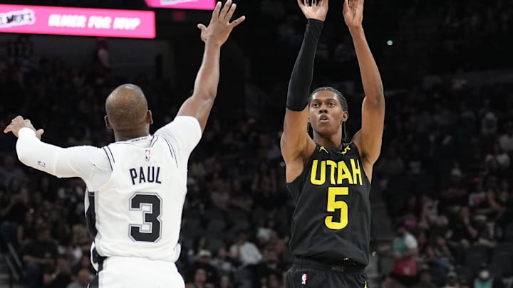 Oct 12, 2024; San Antonio, Texas, USA;  Utah Jazz forward Cody Williams (5) shoots over San Antonio Spurs guard Chris Paul (3) in the first half at Frost Bank Center. Mandatory Credit: Daniel Dunn-Imagn Images