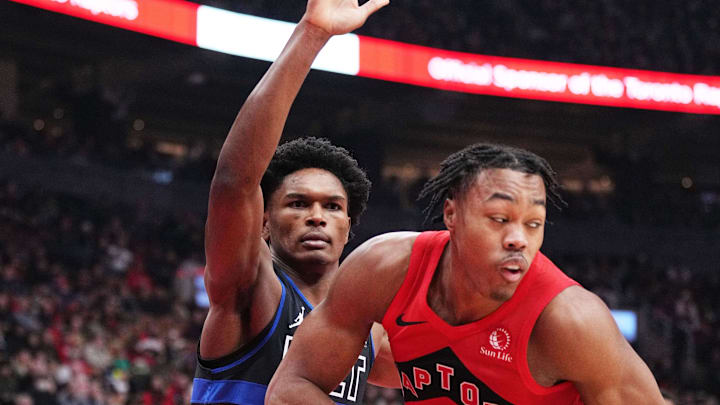 Nov 19, 2023; Toronto, Ontario, CAN; Toronto Raptors forward Scottie Barnes (4) controls the ball as Detroit Pistons forward Ausar Thompson (9) tries to defend during the first quarter at Scotiabank Arena. Mandatory Credit: Nick Turchiaro-Imagn Images