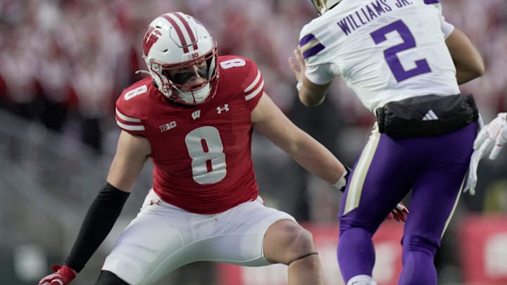 Wisconsin linebacker Mason Posa (8) tackles Washington quarterback Demond Williams Jr. (2) during the first quarter of their game Saturday, November 8, 2025 at Camp Randall Stadium in Madison, Wisconsin.