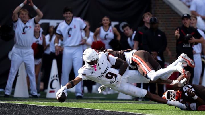 Cincinnati Bearcats wide receiver Jeff Caldwell (9) scores a touchdown as Bowling Green Falcons cornerback MJ Cannon defends in the second quarter of the NCAA football game between the Cincinnati Bearcats and Bowling Green Falcons at Nippert Stadium in Cincinnati on Sept. 6, 2025. Cincinnati Bearcats wide receiver Jeff Caldwell (9) scores a touchdown as Bowling Green Falcons cornerback MJ Cannon defends in the second quarter of the NCAA football game between the Cincinnati Bearcats and Bowling Green Falcons at Nippert Stadium in Cincinnati on Sept. 6, 2025.