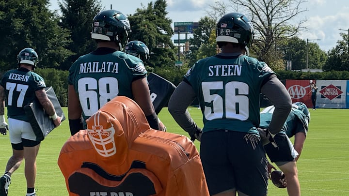 Eagles offensive linemen Jordan Mailata and Tyler Steen watch teammates go through a drill during training camp. Eagles offensive linemen Jordan Mailata and Tyler Steen watch teammates go through a drill during training camp.