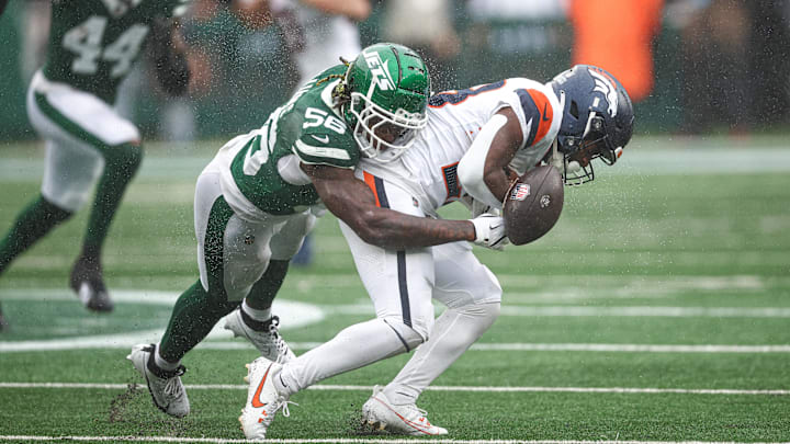 Sep 29, 2024; East Rutherford, New Jersey, USA; Denver Broncos running back Tyler Badie (28) fumbles after being hit by New York Jets linebacker Quincy Williams (56) during the first half at MetLife Stadium. Sep 29, 2024; East Rutherford, New Jersey, USA; Denver Broncos running back Tyler Badie (28) fumbles after being hit by New York Jets linebacker Quincy Williams (56) during the first half at MetLife Stadium.