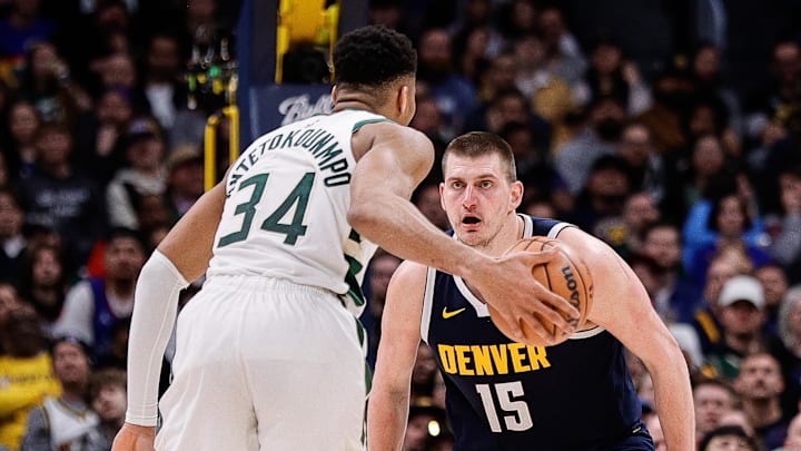 Jan 29, 2024; Denver, Colorado, USA; Milwaukee Bucks forward Giannis Antetokounmpo (34) controls the ball as Denver Nuggets center Nikola Jokic (15) guards in the fourth quarter at Ball Arena.
