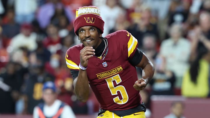 Washington Commanders quarterback Jayden Daniels request the ball after running back Jacory Croskey-Merritt scores.