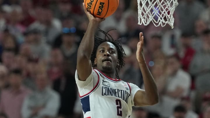 Apr 6, 2024; Glendale, AZ, USA; Connecticut Huskies guard Tristen Newton (2) shoots over Alabama Crimson Tide forward Grant Nelson (2) in the semifinals of the men's Final Four of the 2024 NCAA Tournament at State Farm Stadium. Mandatory Credit: Robert Deutsch-USA TODAY Sports