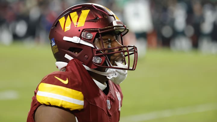 Dec 20, 2025; Landover, Maryland, USA; Washington Commanders wide receiver Treylon Burks (13) sits on the field after a play against the Philadelphia Eagles during the second half at Northwest Stadium. Mandatory Credit: Amber Searls-Imagn Images