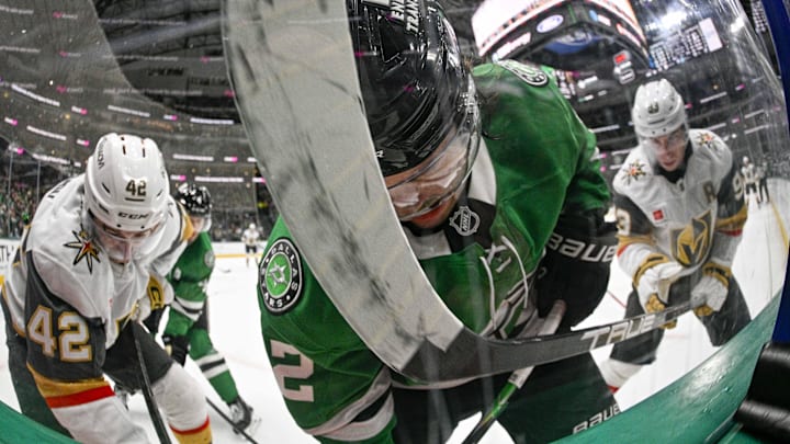Mar 10, 2026; Dallas, Texas, USA; Dallas Stars center Mavrik Bourque (22) attempts to avoid the stick of Vegas Golden Knights right wing Mitch Marner (93) during the third period at the American Airlines Center. Mandatory Credit: Jerome Miron-Imagn Images