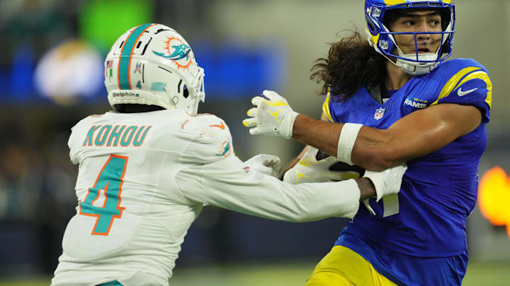 Nov 11, 2024; Inglewood, California, USA; Los Angeles Rams wide receiver Puka Nacua (17) carries the ball against Miami Dolphins cornerback Kader Kohou (4) in the second half at SoFi Stadium. Mandatory Credit: Kirby Lee-Imagn Images