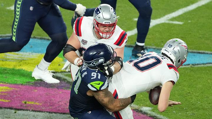 New England Patriots quarterback Drake Maye (10) is sacked by Seattle Seahawks defensive tackle Byron Murphy II (91).
