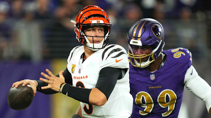 Nov 7, 2024; Baltimore, Maryland, USA; Cincinnati Bengals quarterback Joe Burrow (9) is pressured by Baltimore Ravens linebacker Odafe Oweh (99) during the first quarter at M&T Bank Stadium. Mandatory Credit: Mitch Stringer-Imagn Images