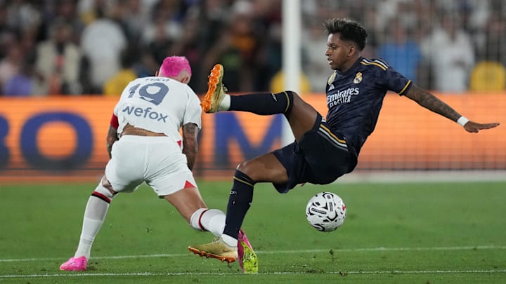 Jul 23, 2023; Pasadena, California, USA; AC Milan defender Theo Hernandez (19) and Real Madrid forward Rodrygo Silva (11) battle for the ball n the second half at the Rose Bowl. Mandatory Credit: Kirby Lee-Imagn Images