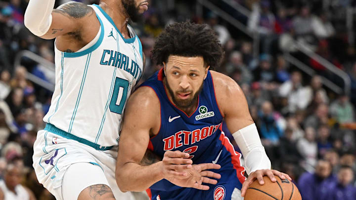 Feb 9, 2025; Detroit, Michigan, USA;  Detroit Pistons guard Cade Cunningham (2) drives past Charlotte Hornets forward Miles Bridges (0) in the first quarter at Little Caesars Arena. Mandatory Credit: Lon Horwedel-Imagn Images
