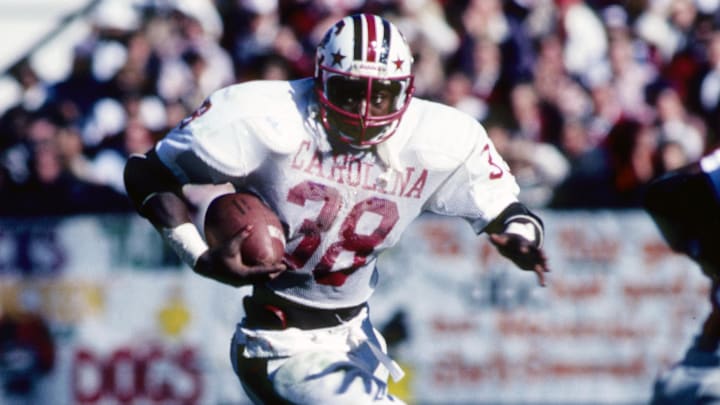 Nov 1, 1980; Athens, GA, USA; FILE PHOTO; South Carolina Gamecocks running back George Rogers (38) carries the ball against the Georgia Bulldogs at Sanford Stadium. Mandatory Credit: Malcolm Emmons-Imagn Images