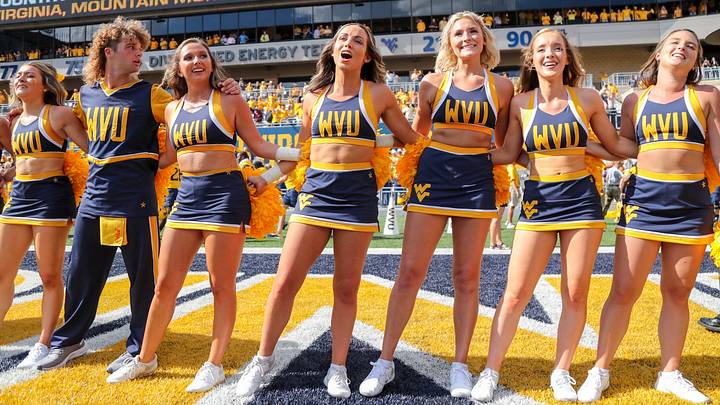 Sep 18, 2021; Morgantown, West Virginia, USA; West Virginia Mountaineers cheerleaders celebrate after defeating the Virginia Tech Hokies at Mountaineer Field at Milan Puskar Stadium. Mandatory Credit: Ben Queen-USA TODAY Sports